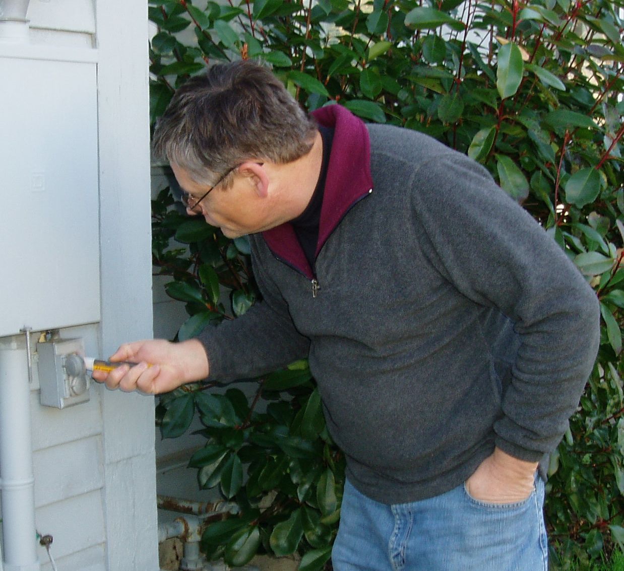 Steven Smith inspects an exterior outlet Photo