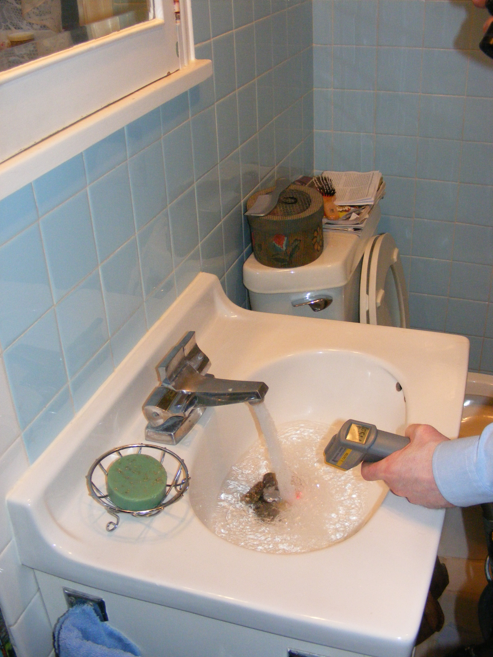 Charles Buell measures water temperature Photo